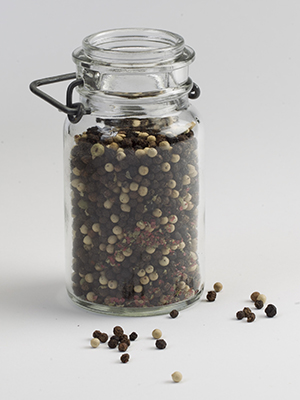 Clear glass jar of peppercorns