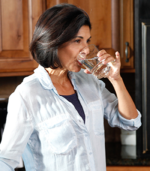 Woman drinking glass of water.