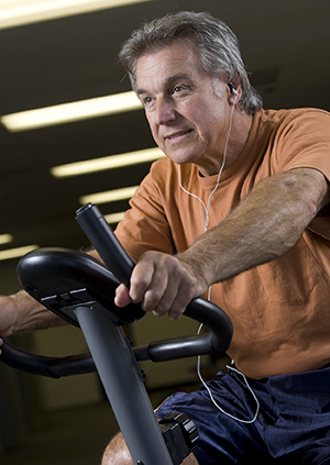 Man using exercise bike.